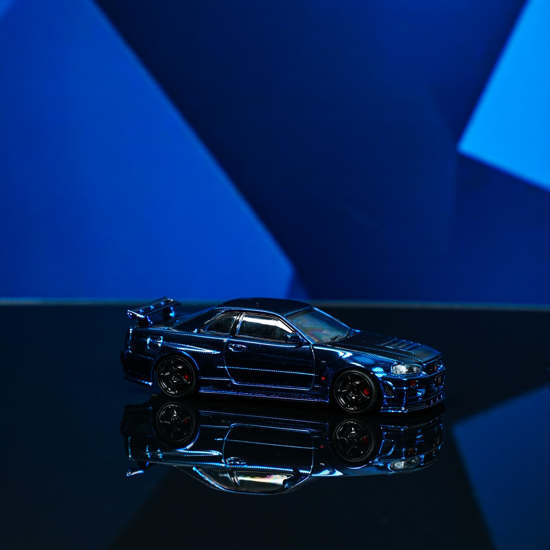 Nissan GTR R34 Blue Carbon TimeTop - model 1:64 - miniatura 1
